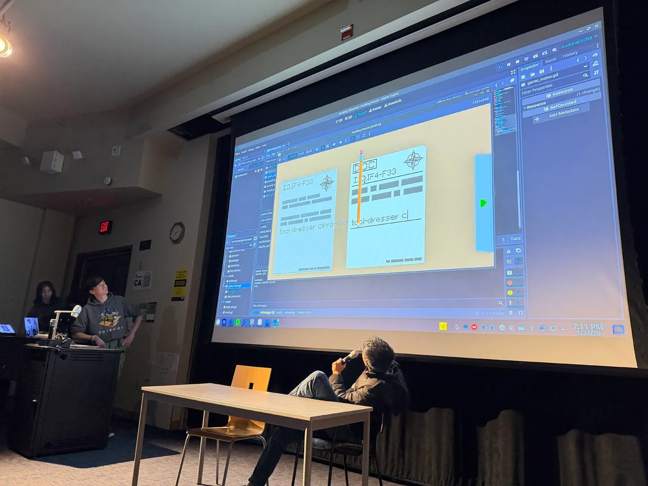 Team members presenting pushing pencils